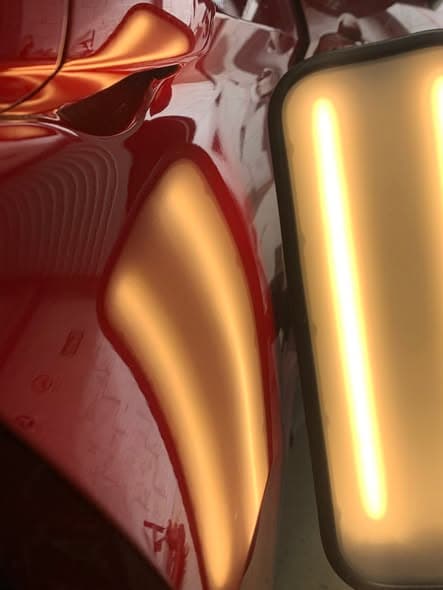 Same panel after paintless dent removal, factory finish restored