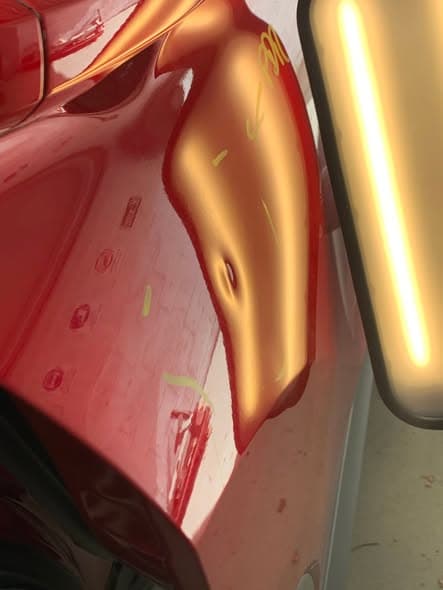 Panel with dent before paintless dent removal